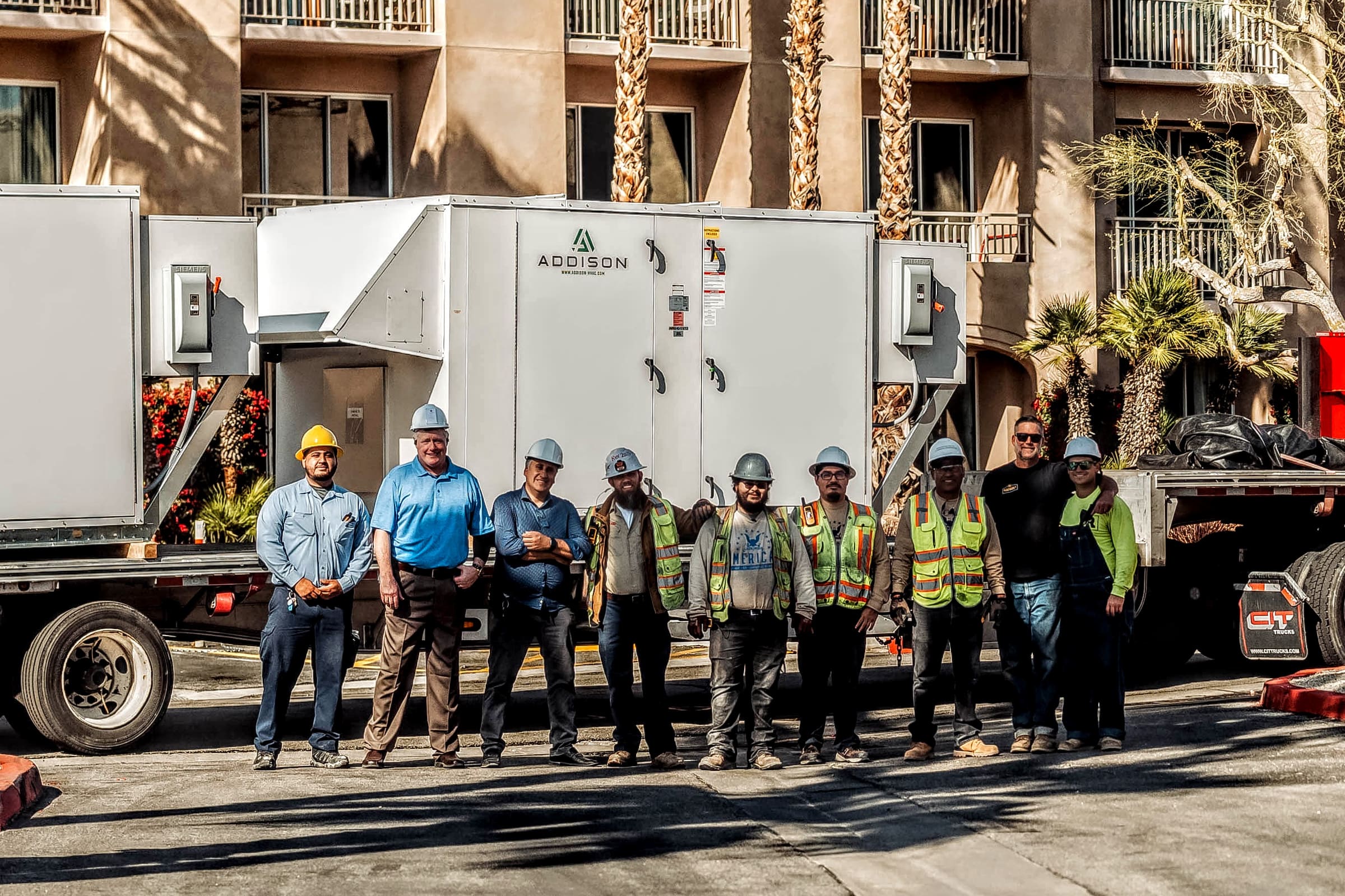 American Cool team standing in front of commercial HVAC equipment at a Coachella Valley project