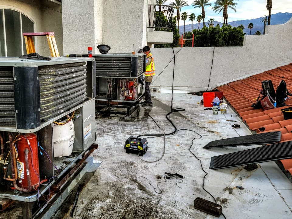 Open rooftop commercial HVAC units undergoing preventive maintenance