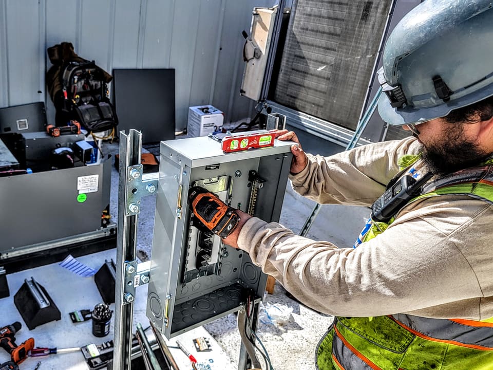 American Cool technician installing controls in new commercial refrigeration equipment
